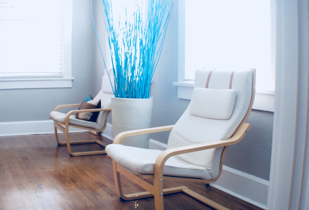 Modern white chairs with blue decor in therapy office